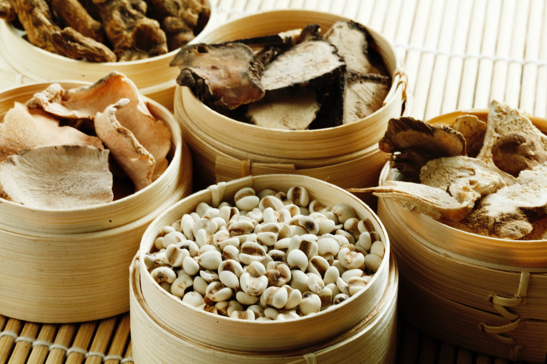 wooden containers with cashew and dried mushrooms